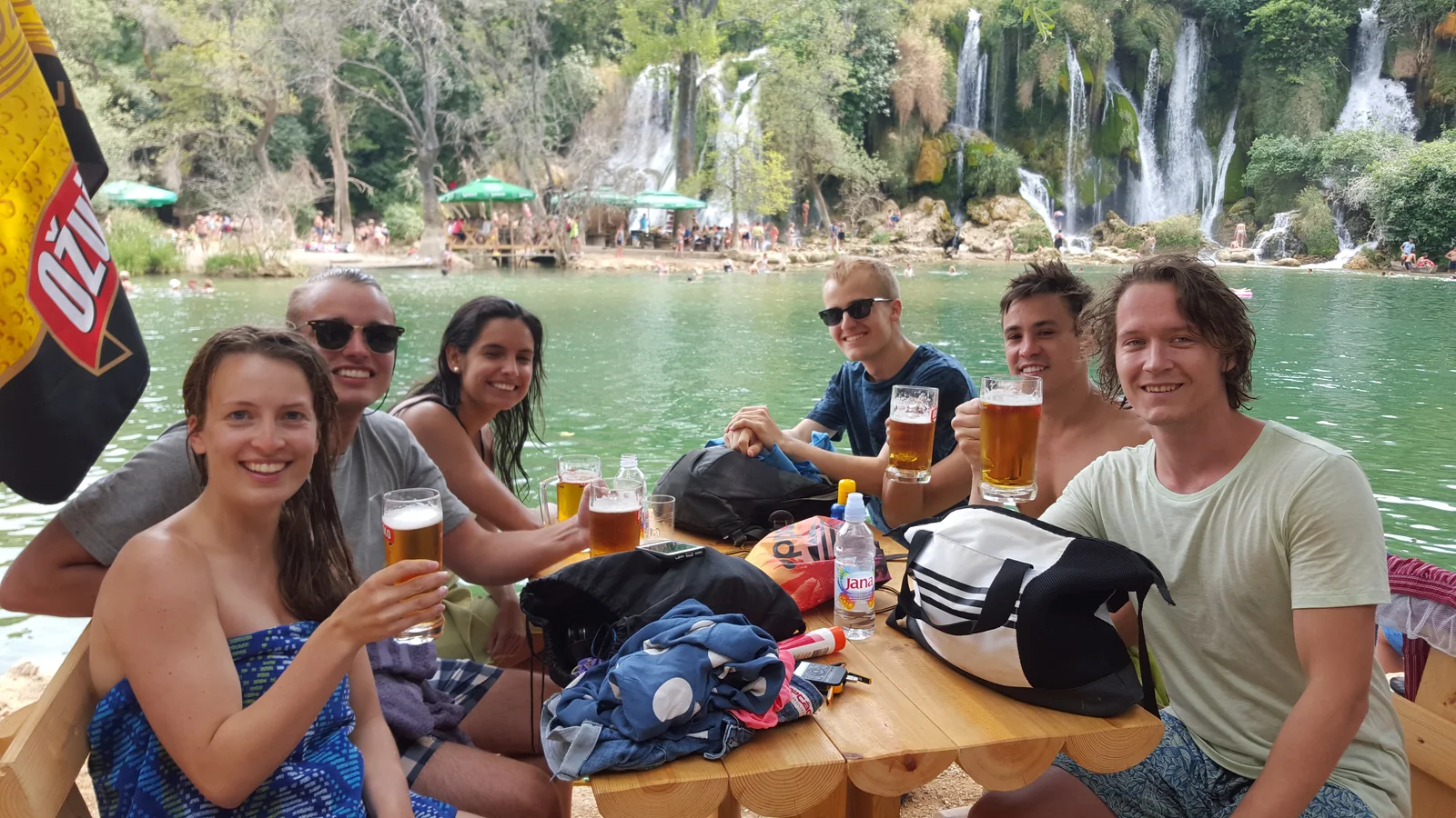Guests swimming in the pool beneath Kravica Waterfall